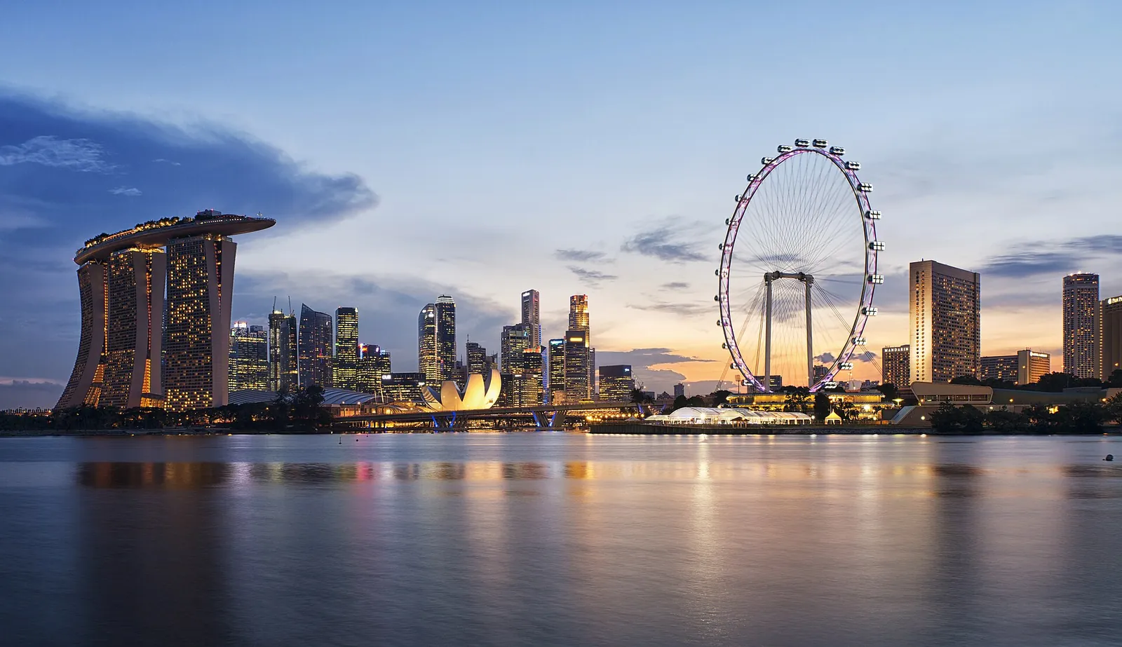 Marina Bay Sands and the Singapore Flyer reflected in the bay at sunset